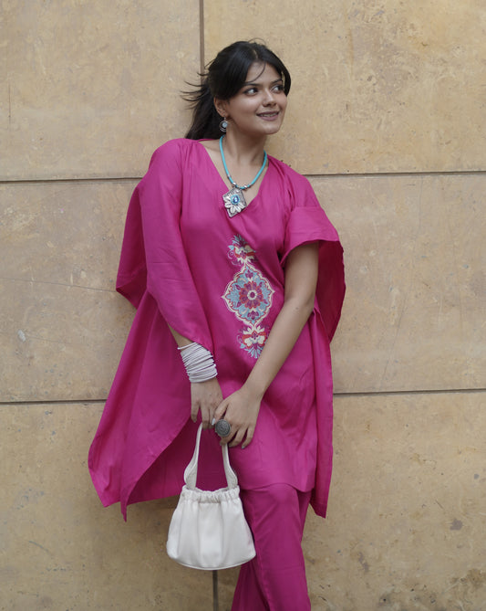 woman wearing magenta kaftan kurta with matching. palazzo pants paired with beautiful accessories.